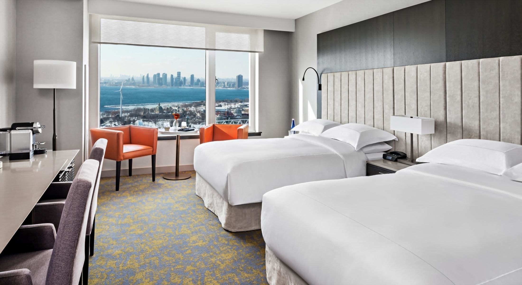 Our Signature Room with 2 Queen Beds features a large desk space, 2 arm chairs, and city views.