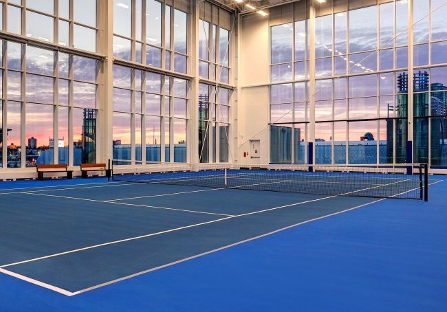 Four Indoor DecoTurf Tennis Courts with an Australian Open two-tone blue color scheme with ceiling to floor windows offering views of the lake and surrounding city while you play your game.
