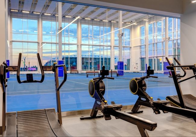 Four Deco Turf indoor tennis courts surfaced by Tennex, with 50-foot ceilings and extraordinary
views of the BMO Field and Exhibition Grounds. There is a TechnoGym alongside the tennis courts, with cardiovascular equipment such as ergometers and curve treadmills as seen in this picture.