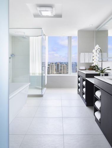 A luxurious, 200 sq ft, bathroom with a large soaking tub and stand alone shower with City Views.